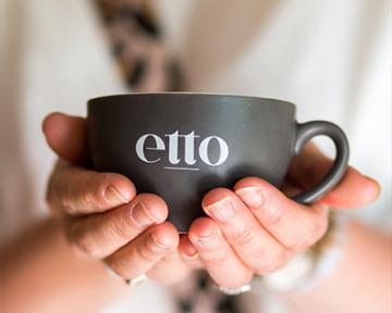 cup of etto coffee held in hands